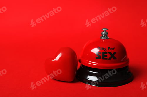 Preview: Sex bell and heart on red background. Space for text
