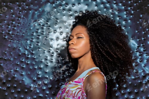 Vista previa: beautiful black woman with closed eyes on a metallic blue background