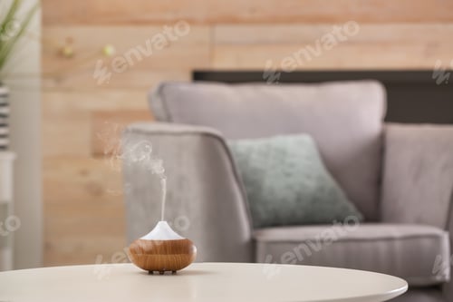 Preview: Aroma oil diffuser lamp on table against blurred background