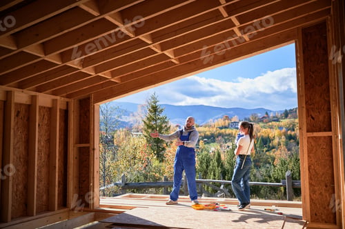 Preview: Father, mother and son building wooden frame house.