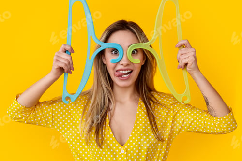 Preview: Crazy woman having fun with clothes hangers