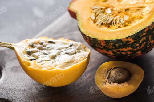 Preview: Close up View of Yellow Sweet Granadilla, Pumpkin And Apricot on Wooden Chopping Boards