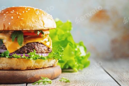 Preview: Two fresh homemade burgers with fried potatoes on a wooden table. With copy space
