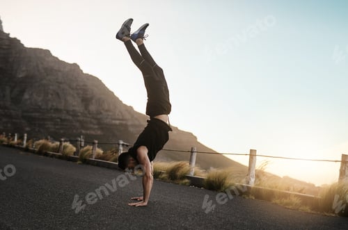 Preview: Shot of a sporty young man doing a handstand while exercising outdoors