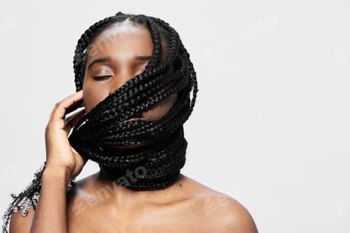 Preview: Young Black woman with braided hair, showcasing confidence and serenity through a striking portrait