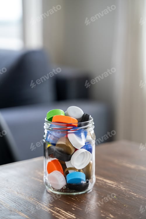 Preview: Glass jar filled with colorful plastic bottle caps