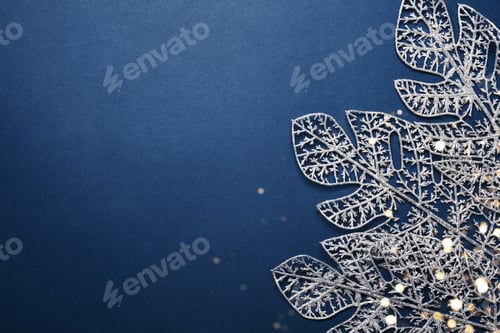 Preview: Christmas blue background. Shining silver pattern made of frost decorative leaves