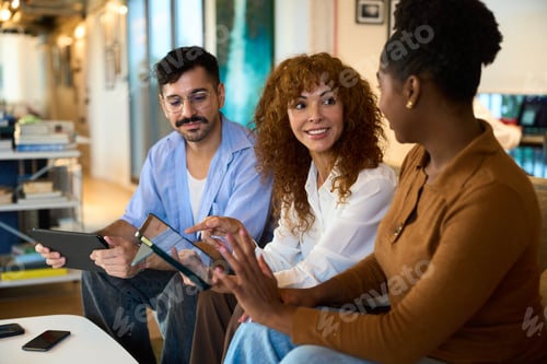 Preview: Diverse colleagues collaborating on digital tablets in office - Financial
