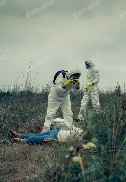 Preview: Man and woman in bacteriological protective suit taking a photo of a corpse