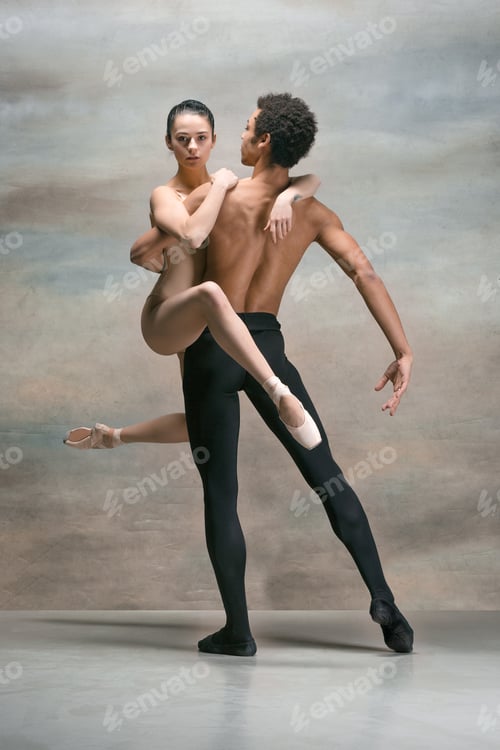 Preview: Couple of ballet dancers posing over gray background