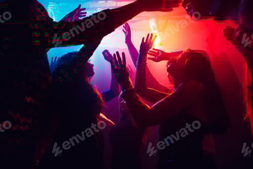 Preview: A crowd of people in silhouette raises their hands against colorful neon light on party background