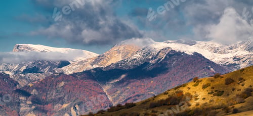 Preview: Beautiful thick clouds over the snowy mountain peak