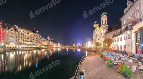 Preview: Gorgeous historic city center of Lucerne with famous buildings and promenade during night.