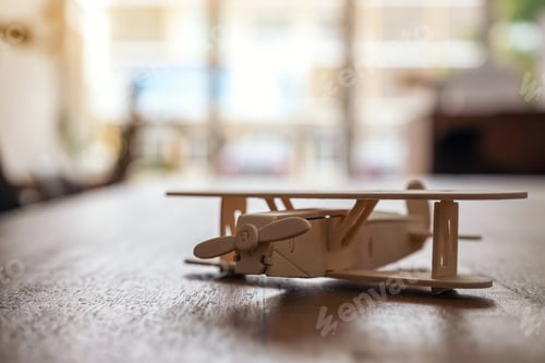 Preview: Closeup image of a wooden airplane on the table