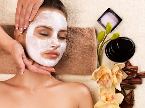 Preview: Woman with mask on her face having head massage.