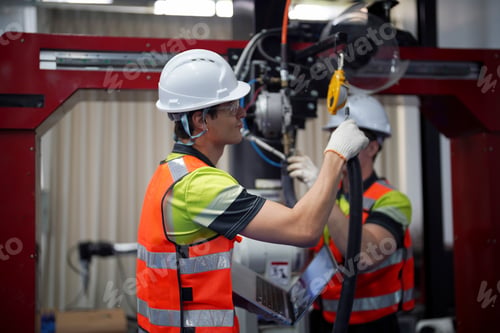 Preview: Engineers working on equipment assembly in a factory during daytime hours