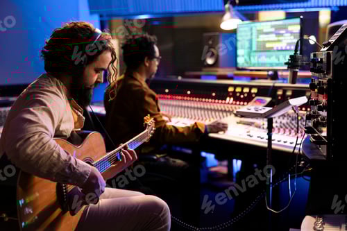 Preview: Skilled artist musician recording his guitar sounds in professional studio