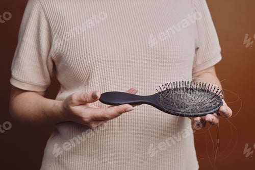 Preview: Woman Holding Hairbrush Close Up
