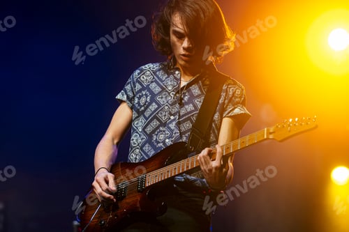 Preview: Guitarist performing at a live concert.