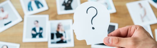 Preview: panoramic shot of man holding paper with human head and question mark near photos