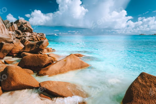 Preview: Beautifully shaped granite boulders and blue lagoon at Grand Anse beach, La Digue island, Seychelles