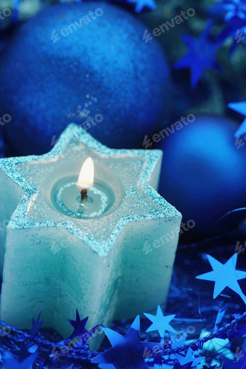 Preview: Blue star candle and blue christmas decorations close up with copy space