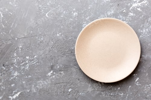 Preview: Top view of empty light plate on cement background. Empty space for your design