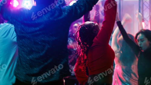 Preview: Cheerful persons jumping at nightclub