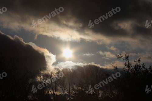 Preview: Sun And Clouds At Sunset - Photograph Of A Setting Sun With Dramatic Clouds And Some Iridescence In