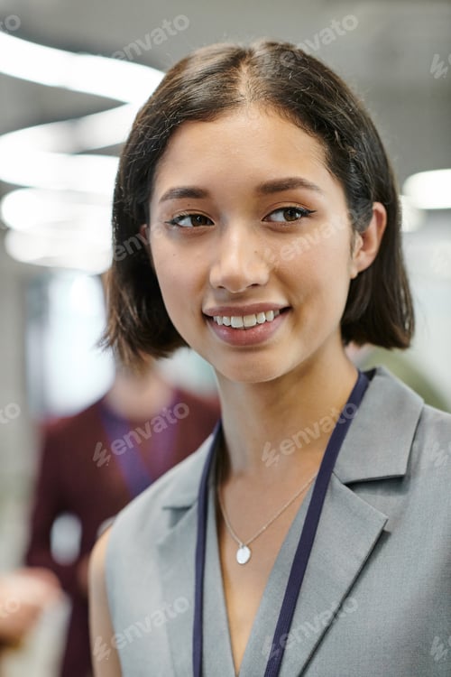 Preview: happy brunette woman looking away in modern office, business success, professional headshot