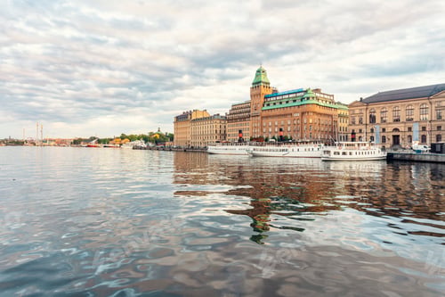 Preview: Nybroviken bay in the center of Stockholm with boats and luxury hotels in the background in summer