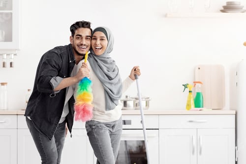 Preview: Loving muslim couple cleaning floor and having fun in kitchen