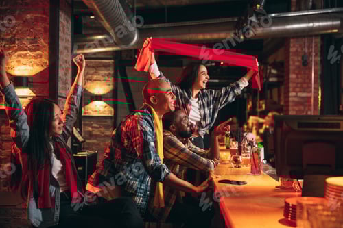 Preview: Group of friends watching sport match together. Concept of friendship, leisure activity, emotions