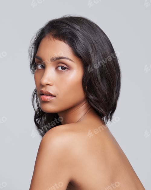 Preview: All natural beauty. Shot of a beautiful young posing over a gray background.