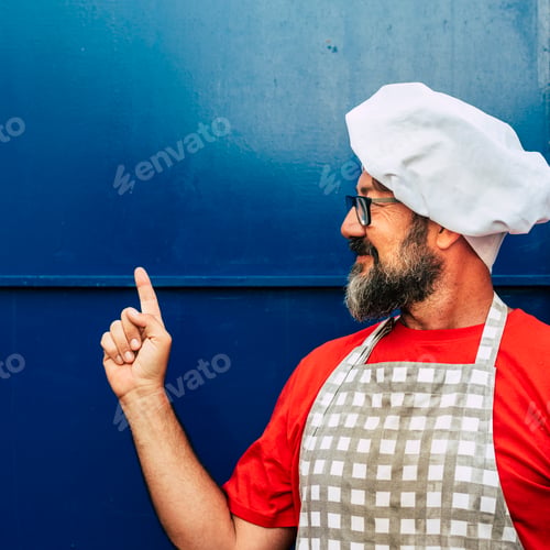Preview: Copy space chef cooking and kitchen concept with adult caucasian man with chef hat