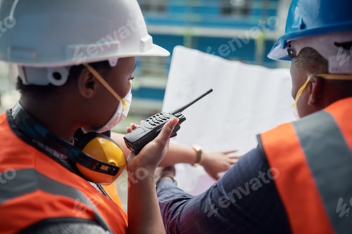 Preview: Shot of a young man and woman going over building plans at a construction site