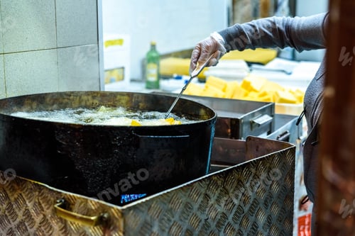 Preview: Pot with boiling oil to prepare the typical Polenta Gialla, boiled corn flour