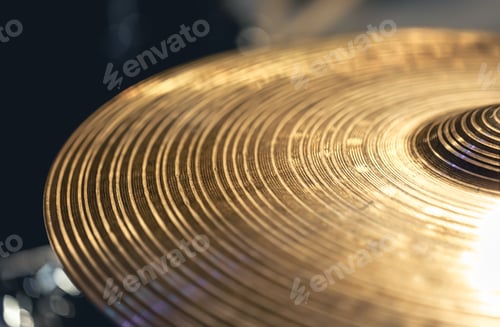 Preview: Drum cymbal close-up on a dark background.