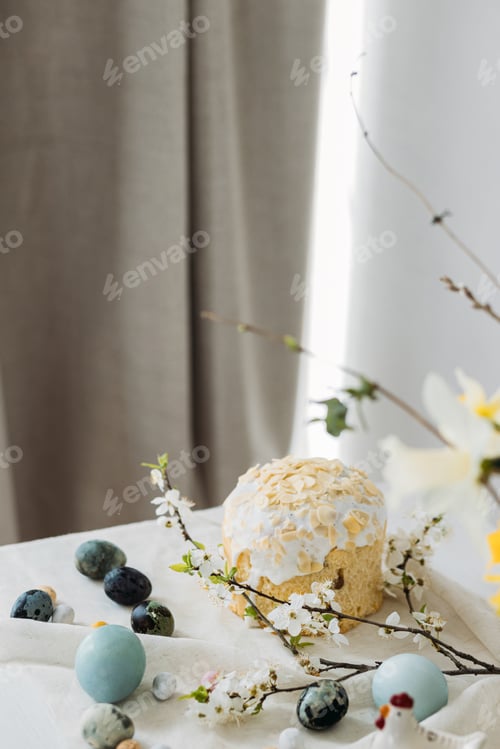 Preview: Stylish easter eggs, panettone and spring flowers on linen cloth on rustic table