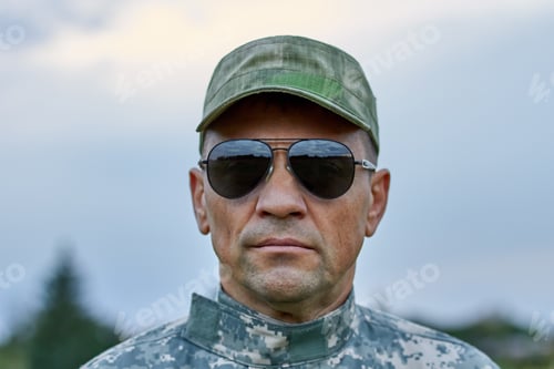 Preview: Close up portrait of strong serious soldier.
