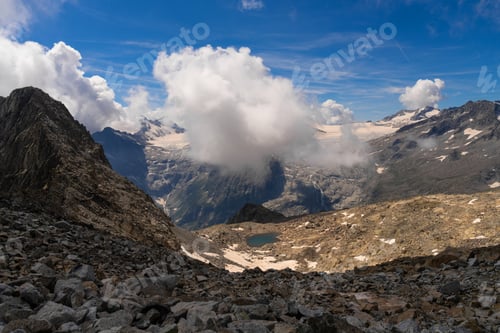 Preview: Majestic Mountain Range with Rocky Terrain and Cloud Cover