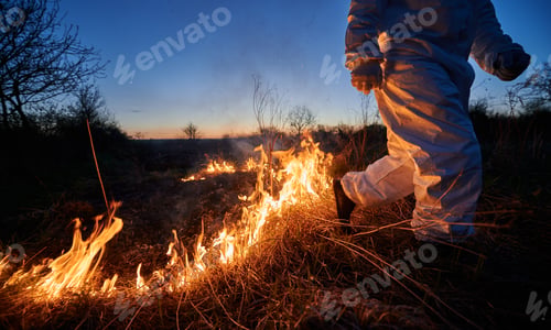 Preview: Firefighter ecologist working in field with wildfire.