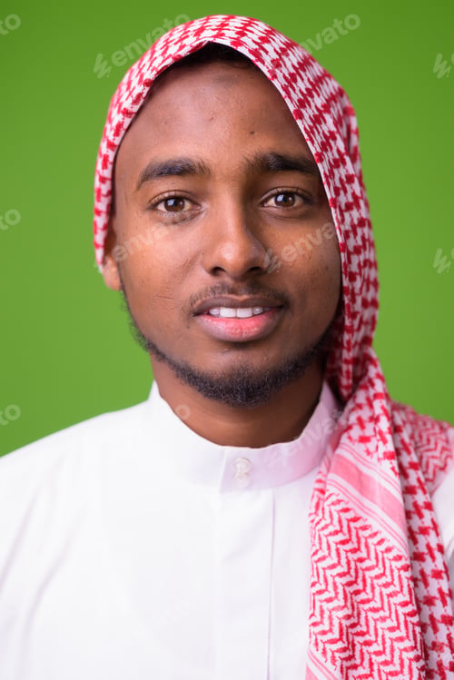 Preview: Young handsome African man wearing traditional Muslim clothes ag