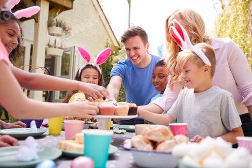Preview: Parents With Children Wearing Bunny Ears Enjoying Outdoor Easter Party In Garden At Home