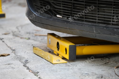 Preview: Car immobilizer device used on vehicle in urban parking area