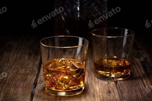 Preview: Two glass of whiskey with ice and crystal decanter
