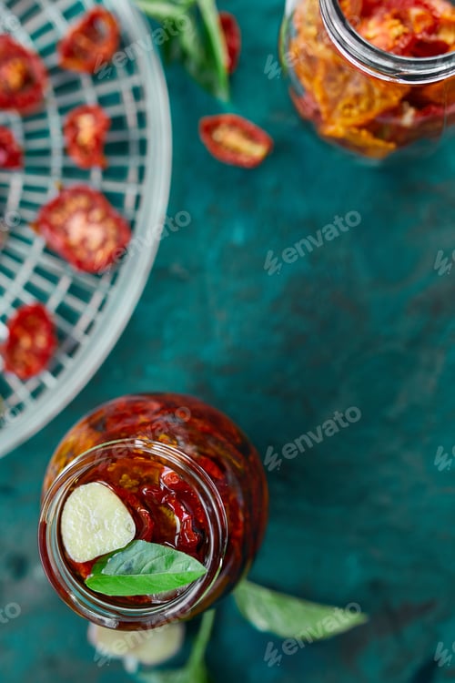 Preview: Homemade sun dried tomatoes with herbs, garlic in olive oil in a glass jar