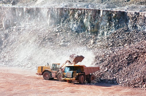 Preview: earth mover loading stones on a dumper truck. mining industries.