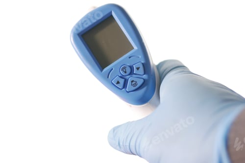 Preview: Hand holding infrared thermometer to measuring temperature.