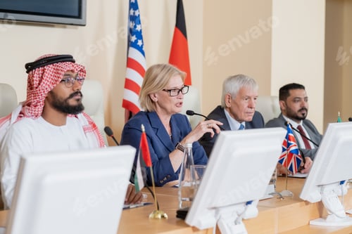 Preview: Blond mature female delegate making speech for audience